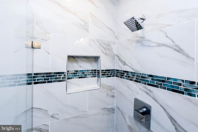 bathroom with a tile shower