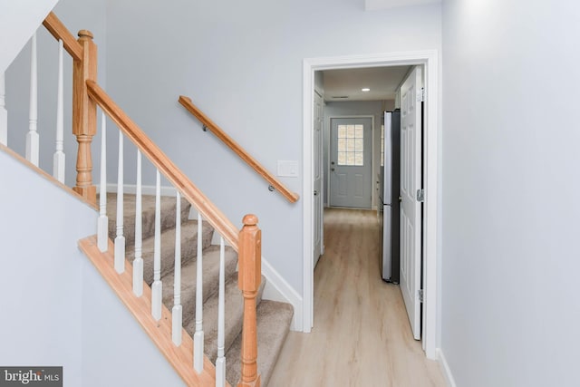 stairway with hardwood / wood-style floors