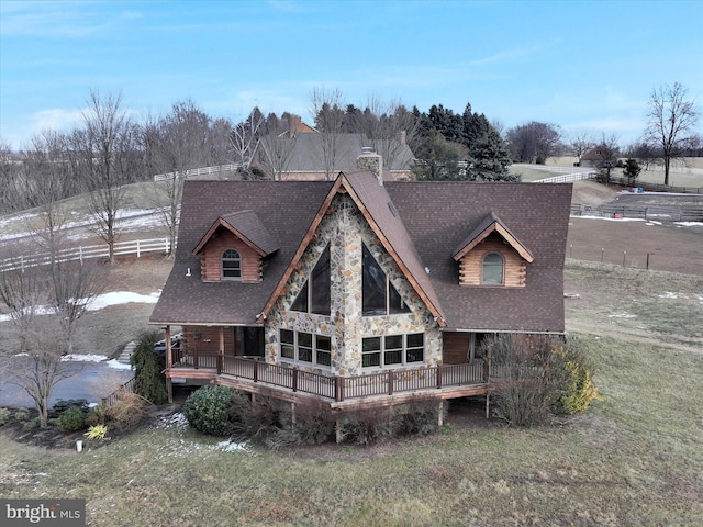 back of house featuring a lawn and a deck