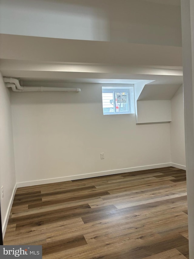 basement featuring dark hardwood / wood-style flooring