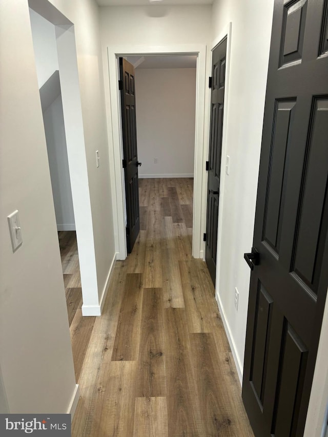 hallway with light hardwood / wood-style flooring