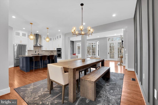 dining room with recessed lighting, light wood-style floors, and visible vents