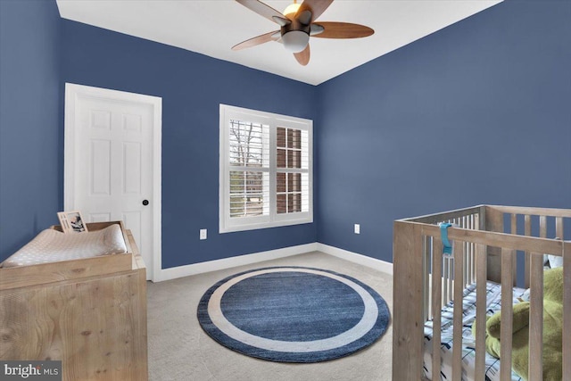 carpeted bedroom featuring a ceiling fan and baseboards