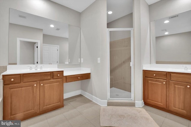 bathroom with tile patterned floors, a stall shower, vanity, and baseboards