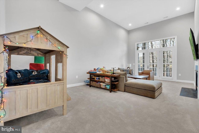 interior space featuring a high ceiling, recessed lighting, baseboards, and french doors