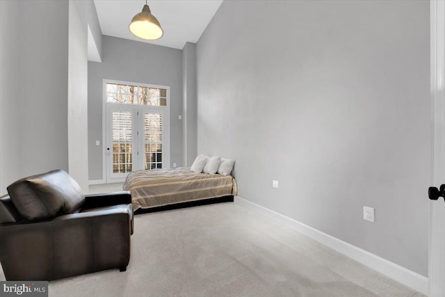 bedroom with access to exterior, baseboards, and carpet floors