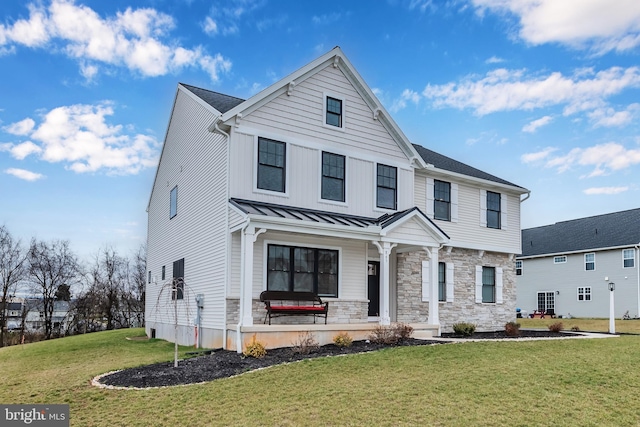 view of front facade with a front lawn and covered porch