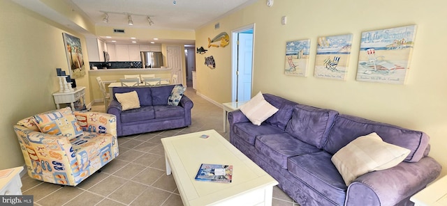 tiled living room featuring rail lighting