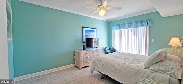 bedroom featuring a textured ceiling, ceiling fan, ornamental molding, and light hardwood / wood-style floors