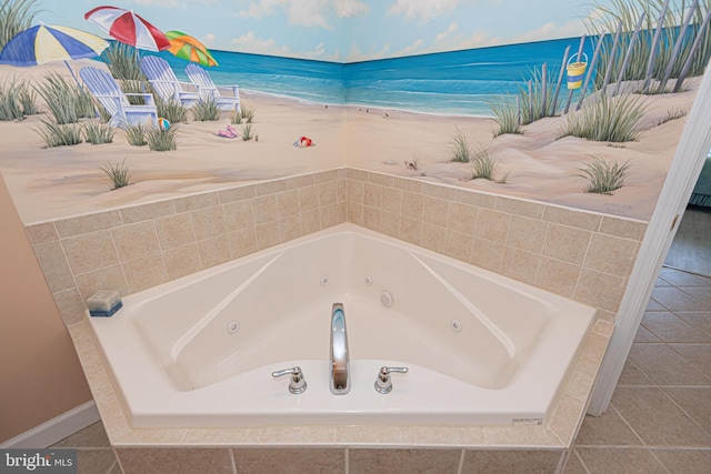 bathroom featuring a water view, tile patterned flooring, and tiled tub