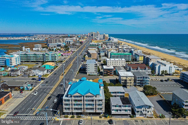 bird's eye view featuring a water view and a beach view