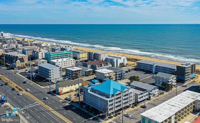 birds eye view of property with a water view and a view of the beach