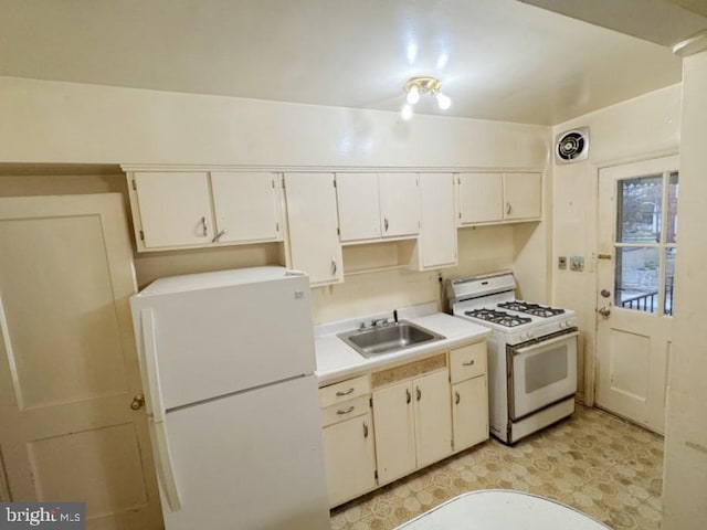 kitchen featuring white cabinetry, sink, and white appliances