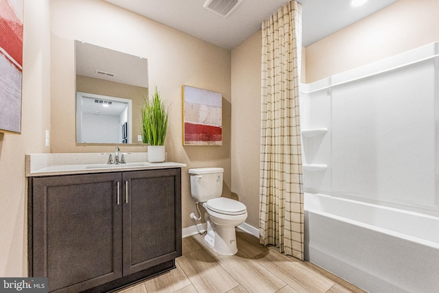 full bathroom with shower / bath combo with shower curtain, toilet, and vanity