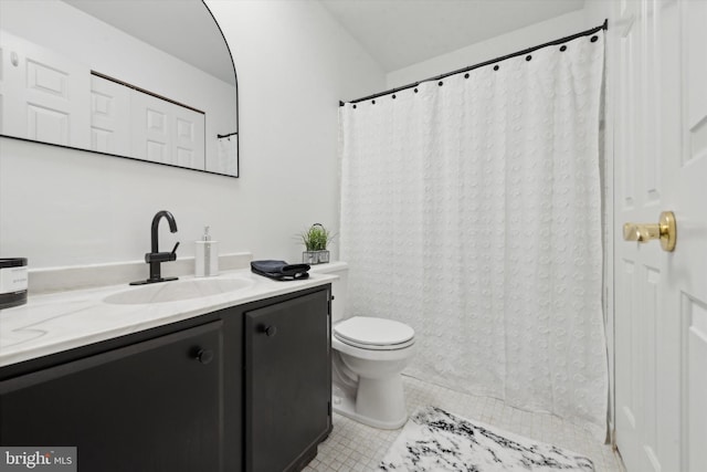 bathroom with toilet, tile patterned floors, and vanity