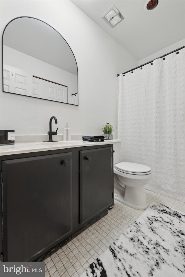 bathroom with toilet and vanity