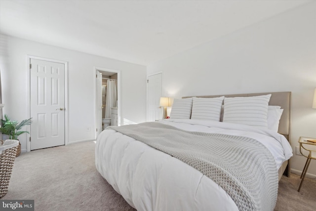 carpeted bedroom with ensuite bathroom