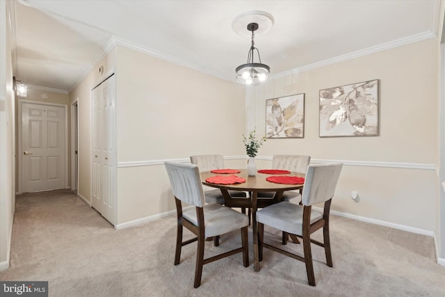 dining room featuring light carpet and crown molding