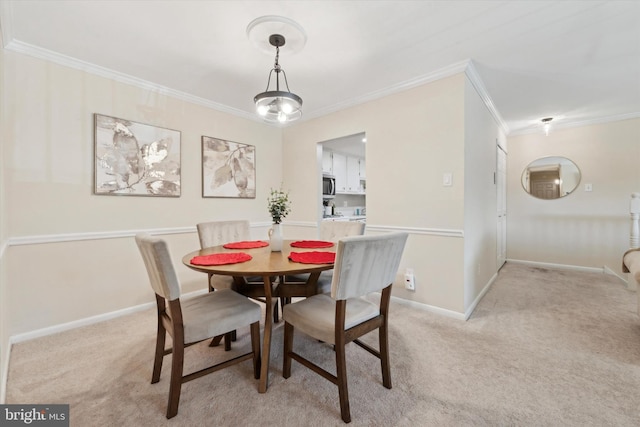 carpeted dining area with crown molding