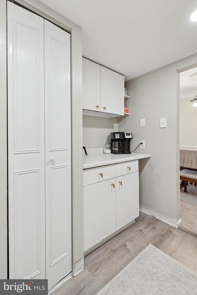 kitchen featuring white cabinetry and light hardwood / wood-style floors