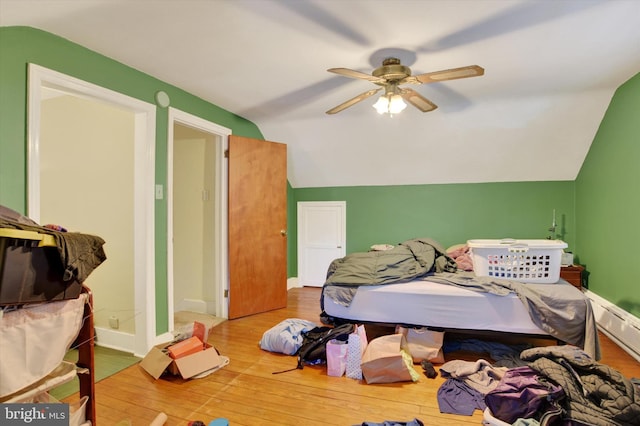 bedroom featuring ceiling fan, lofted ceiling, and hardwood / wood-style flooring