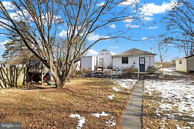 view of snow covered rear of property