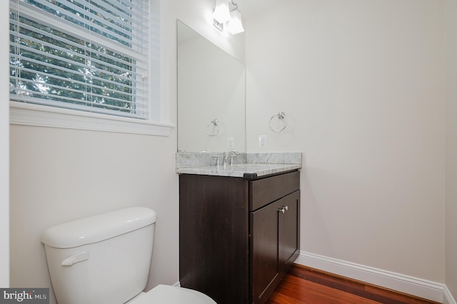 bathroom with vanity, wood-type flooring, and toilet