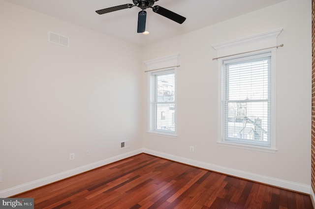 spare room with hardwood / wood-style flooring and ceiling fan