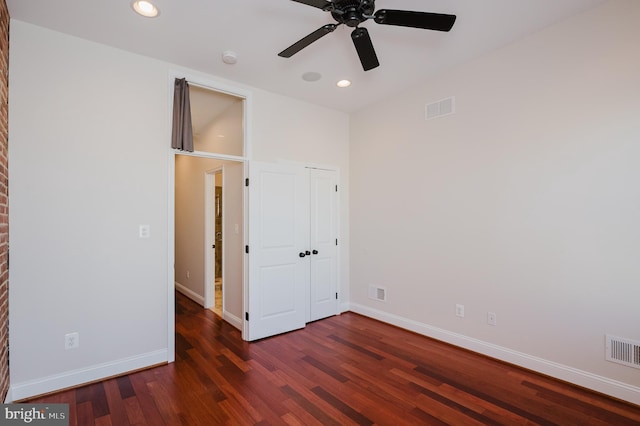 unfurnished bedroom featuring dark hardwood / wood-style floors and ceiling fan