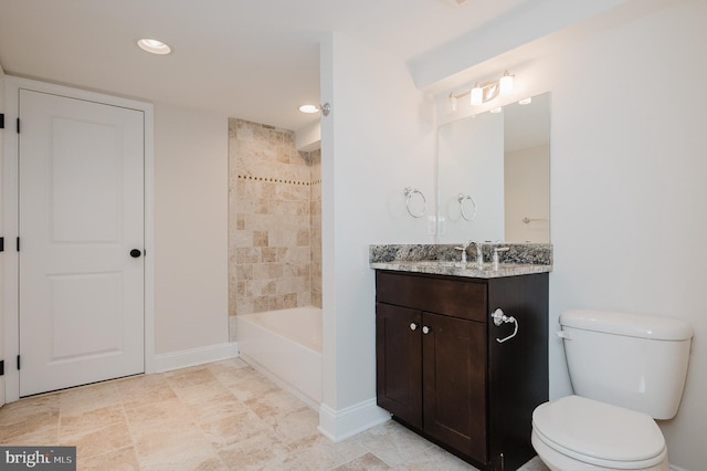 full bathroom with vanity, tiled shower / bath combo, and toilet