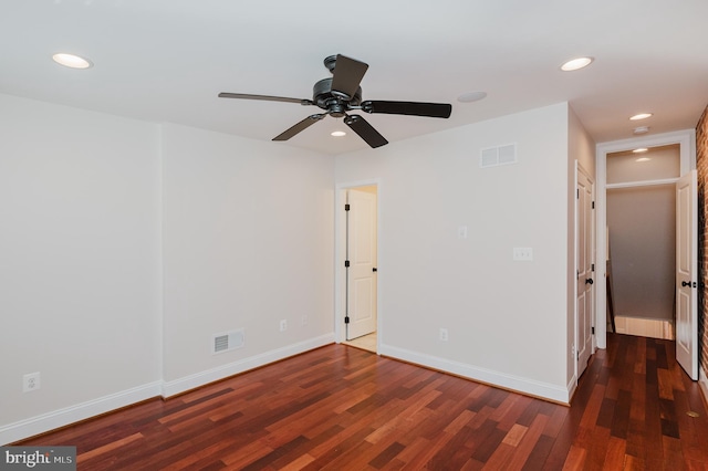 spare room featuring dark hardwood / wood-style flooring and ceiling fan