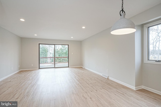 unfurnished room with light hardwood / wood-style floors and plenty of natural light