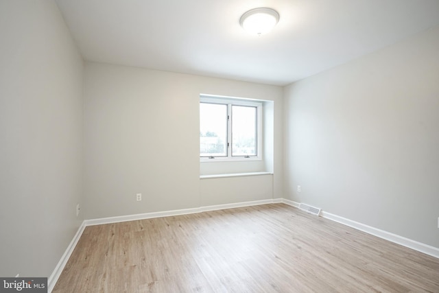 unfurnished room with light wood-type flooring