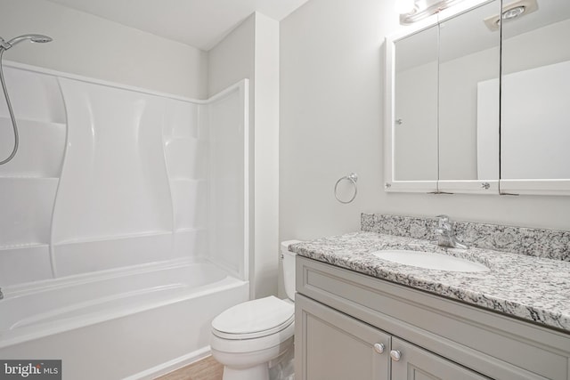 full bathroom featuring toilet, vanity, and  shower combination