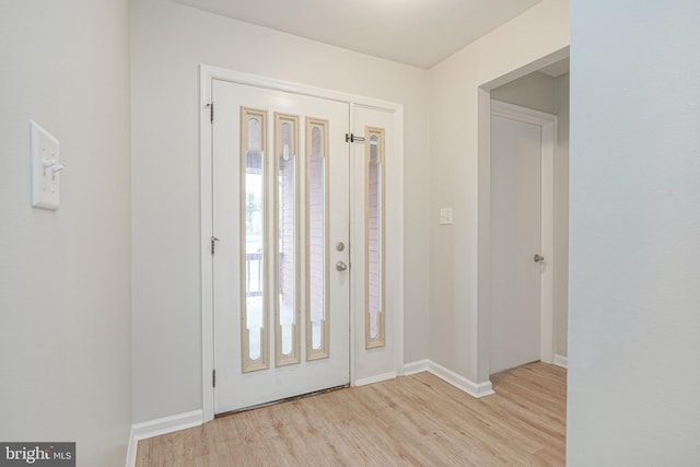 foyer entrance with light hardwood / wood-style flooring