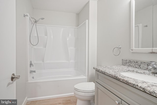 full bathroom with toilet, wood-type flooring, shower / washtub combination, and vanity