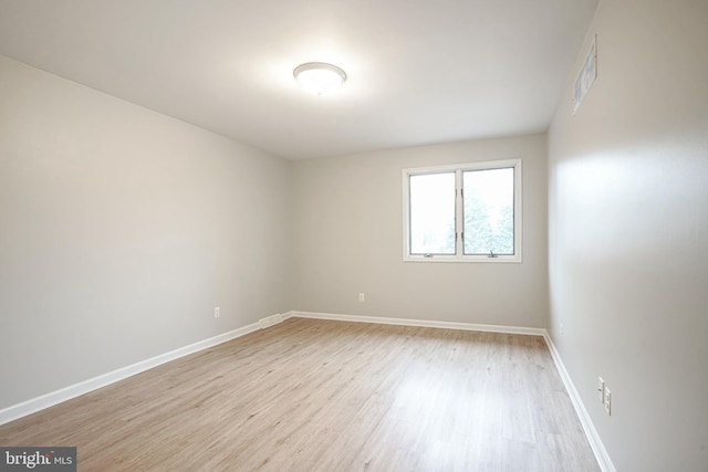 unfurnished room with light wood-type flooring