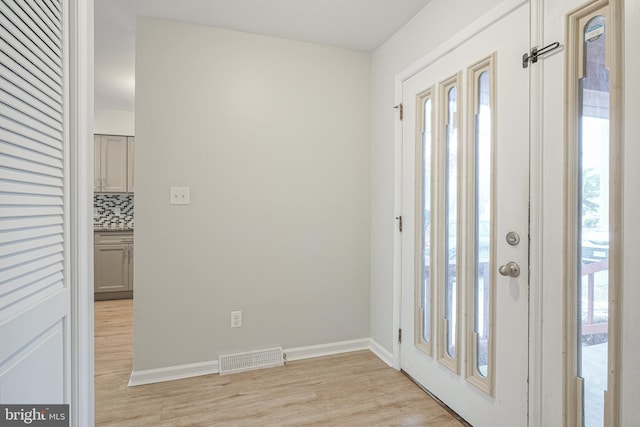 foyer entrance with light wood-type flooring