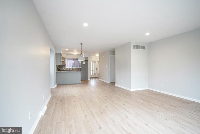 unfurnished living room with light wood-type flooring