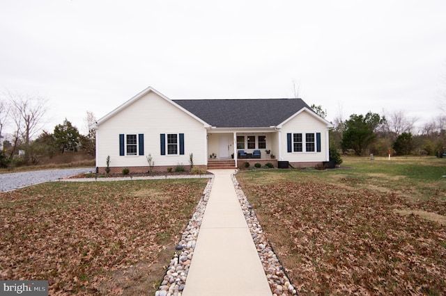 ranch-style home with a front yard and covered porch