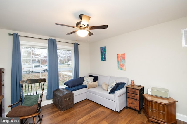 living room featuring hardwood / wood-style flooring and ceiling fan