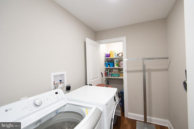 laundry area featuring dark hardwood / wood-style flooring and washer and dryer