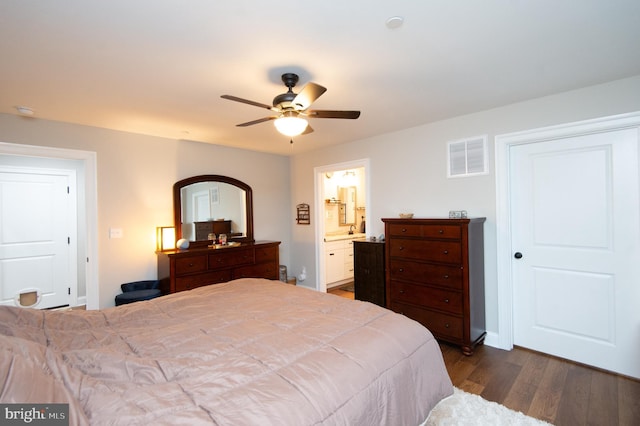 bedroom with dark hardwood / wood-style flooring, ensuite bath, and ceiling fan