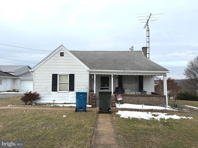 view of front facade with a garage, covered porch, and a front yard