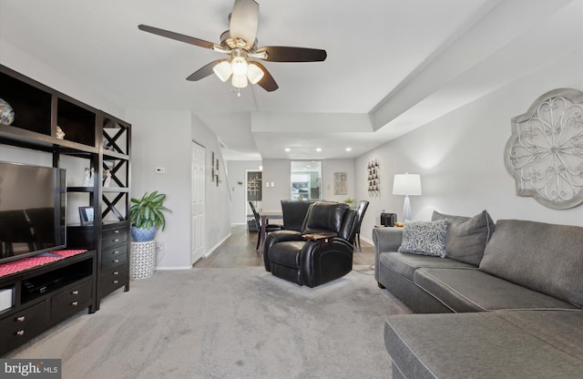 carpeted living room with ceiling fan