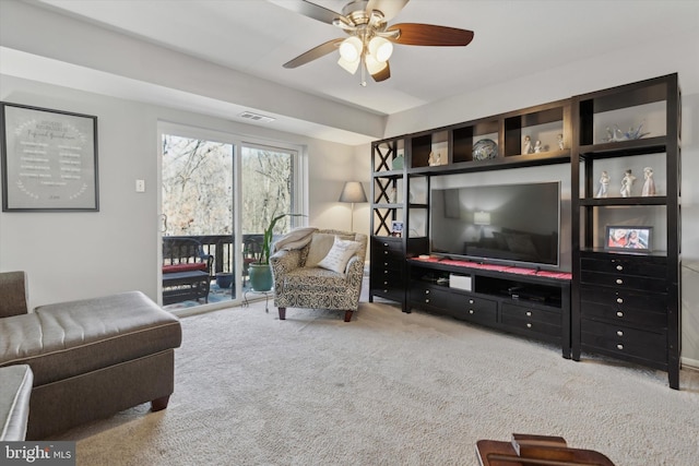 living room with ceiling fan and light colored carpet