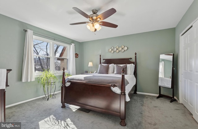 bedroom featuring light carpet, ceiling fan, and a closet