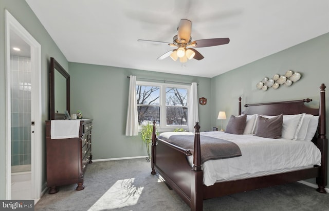 bedroom with ceiling fan, light colored carpet, and ensuite bath