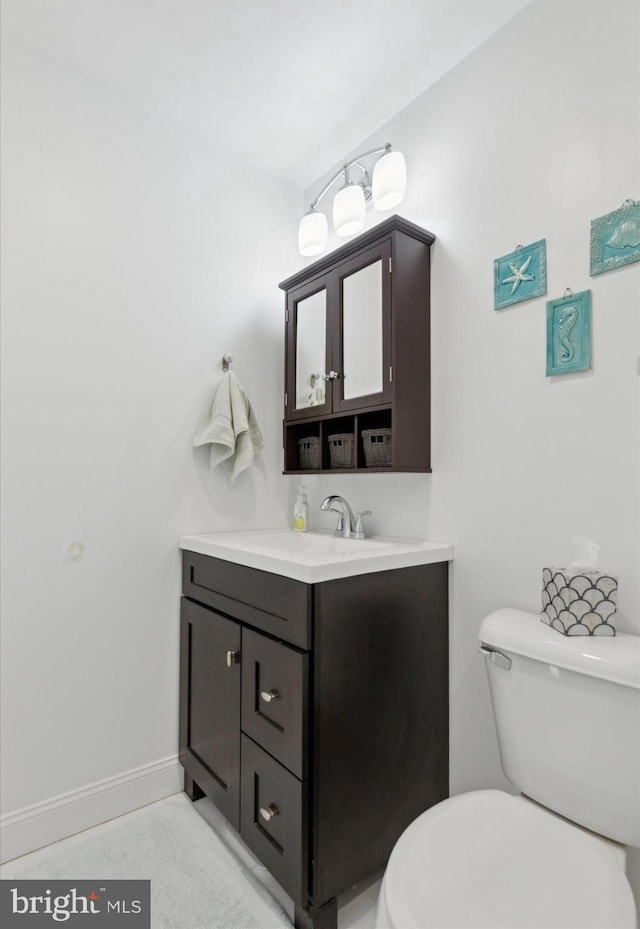 bathroom with toilet and vanity