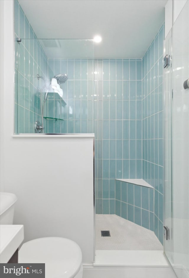 bathroom featuring vanity, toilet, and an enclosed shower